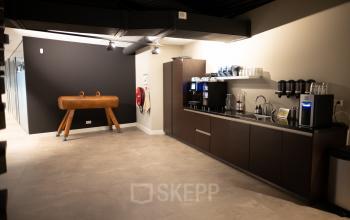 Pantry area in an office at Olympisch Stadion 24-28, Amsterdam Old South. Includes coffee machines, cups, and a gymnastic horse for decoration.