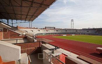 Exterior view of Olympisch Stadion 24-28 in Amsterdam Old South, featuring the stadium's seating and track field.