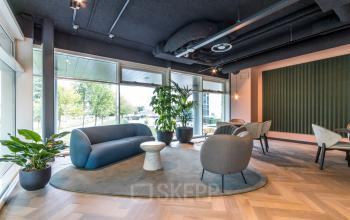 Modern office space in Amsterdam Riekerpolder with stylish seating and large windows for office space rental.