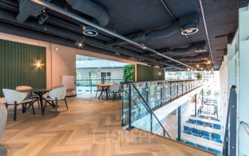 Spacious office interior at John M. Keynesplein 4-10, Amsterdam Riekerpolder, featuring modern furnishings and an inviting open floorplan, perfect for office space rental.