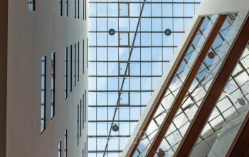 Interior view of an Amsterdam Riekerpolder office with a large skylight and multiple floors visible.