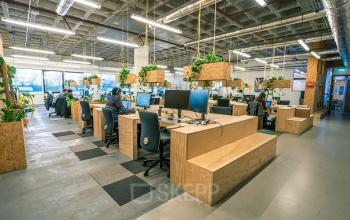Spacious office space rental at Johan Huizingalaan 761-763 a, Amsterdam Riekerpolder, with plants and modern open workspaces, busy with professionals.