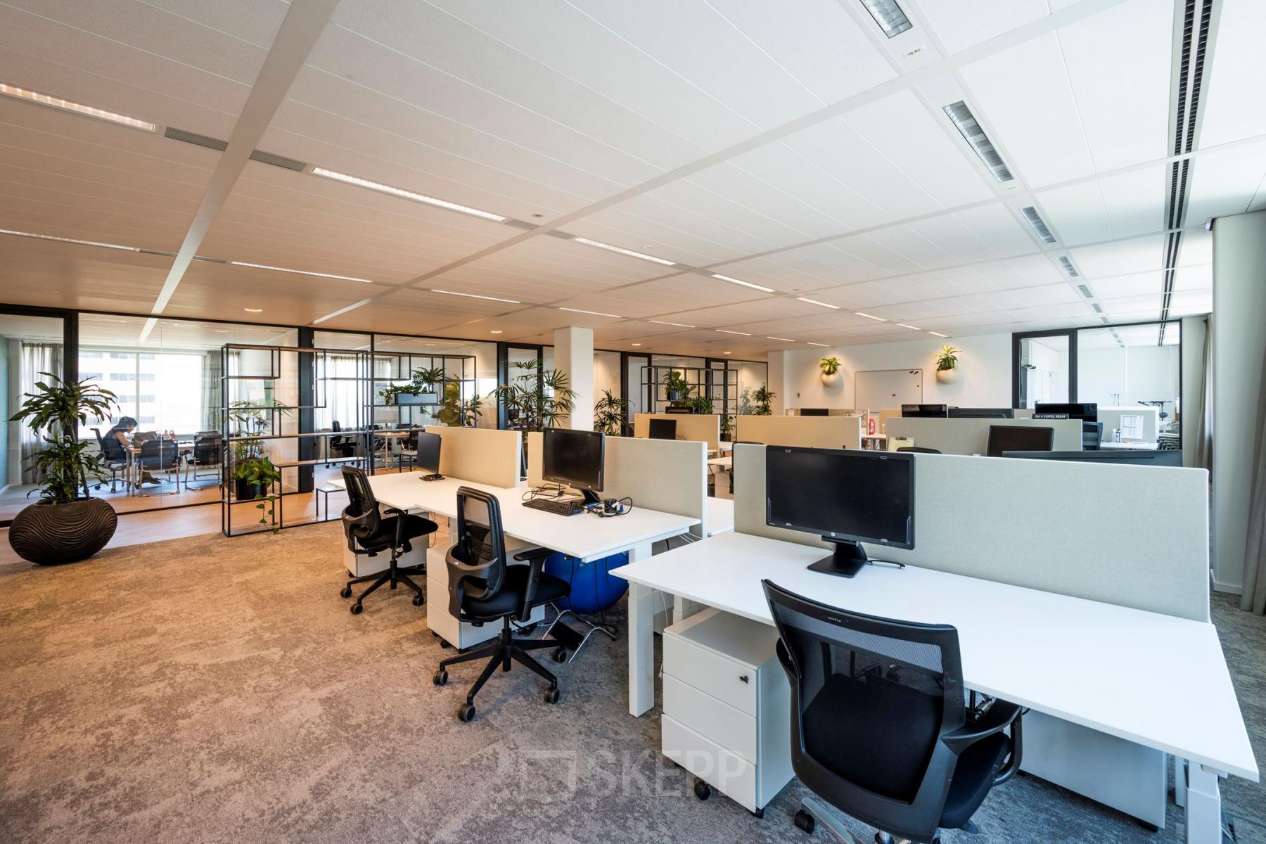 Spacious, modern workspaces with desks and computers at office to rent on Thomas R. Malthusstraat 1-3, in Amsterdam Riekerpolder.
