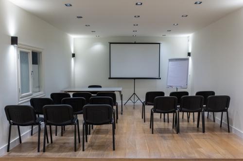 Modern conference room at Poortland 66, Amsterdam Sloterdijk, featuring a projector, screen, and arranged seating, ideal for office space rental.