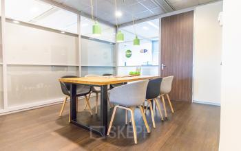 Bright office space with a wooden table and stylish chairs available for rent at Radarweg 29, Amsterdam Sloterdijk.