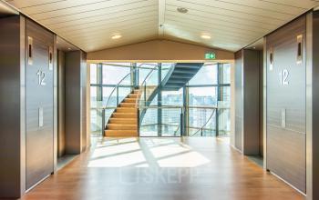 Bright foyer area with a staircase and an expansive view, located at Radarweg 29, Amsterdam Sloterdijk, ideal for office space rental.