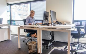 Modern office space for rent at Radarweg 29, Amsterdam Sloterdijk, featuring a professional setup with large windows and desks in use by professionals.