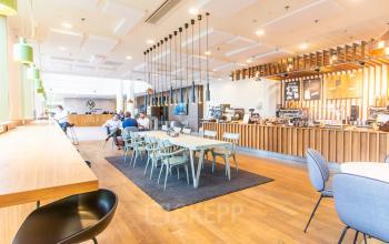 Bright workspace at Radarweg 29, Amsterdam Sloterdijk, featuring a modern interior with communal seating, ideal for those seeking office space rental.