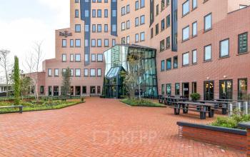 Modern office space rental at Kingsfordweg 151, in Amsterdam Sloterdijk with a landscaped approach and glass facade.