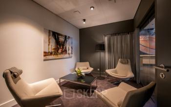 Comfortable office space rental at Teleportboulevard 110, Amsterdam Sloterdijk, featuring modern furnishings and stylish seating ideal for small meetings or relaxation.