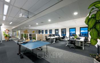 Modern office space at Radarweg 501, Amsterdam Sloterdijk, featuring workstations, a ping pong table, and plants, ideal for rent office space seekers.