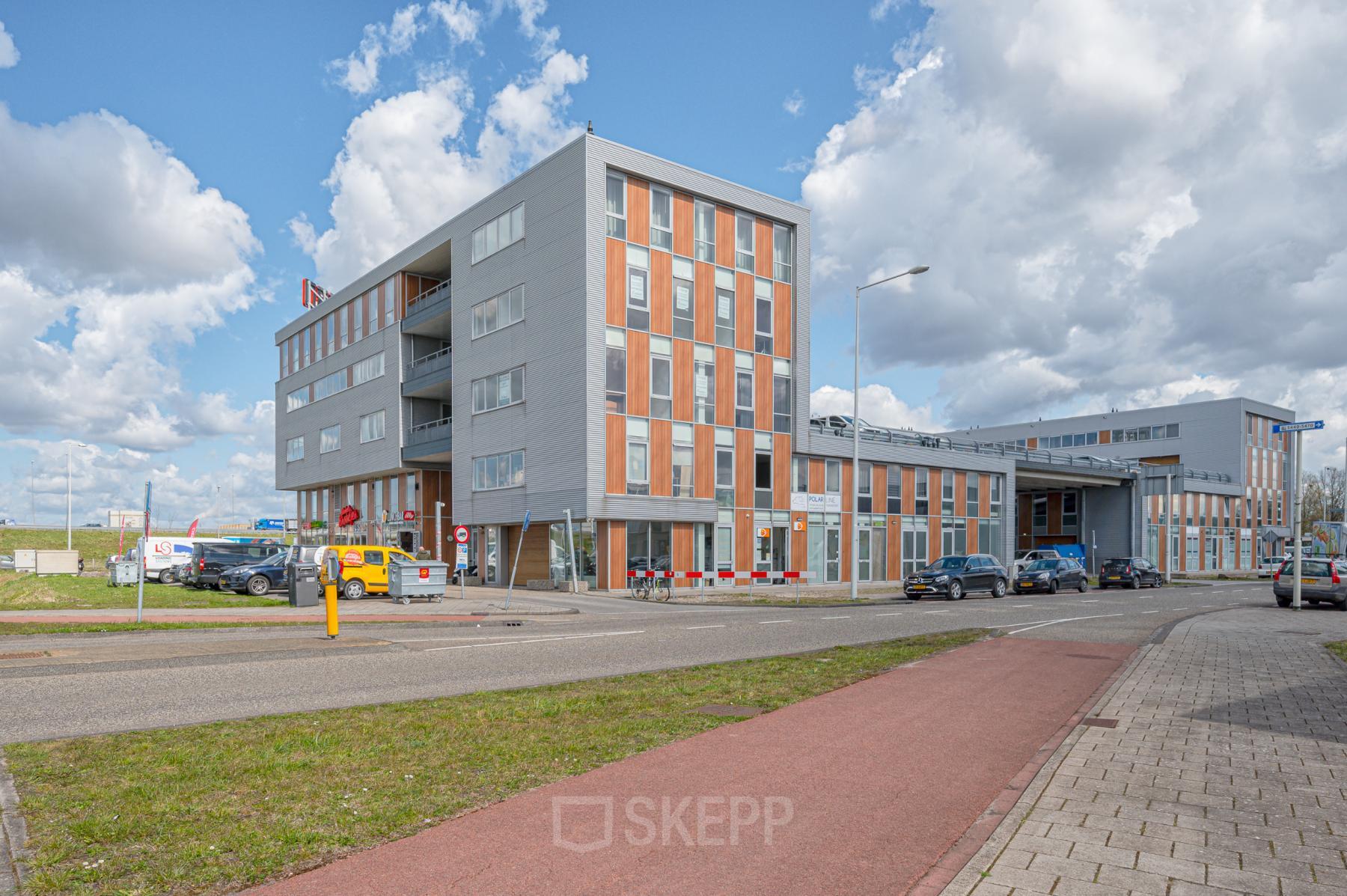 Modern office building at Tijnmuiden 59, Amsterdam Sloterdijk, ideal for office space rental. The exterior features a contemporary design with ample windows and parking access.