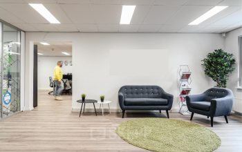 Modern furnished office space rental at Arlandaweg 92, Amsterdam Sloterdijk, featuring a waiting area with sofas and a small table.