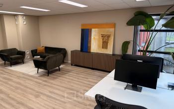Furnished office space rental at Arlandaweg 92, Amsterdam Sloterdijk, featuring modern workstations, seating area, and decor.