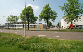 Exterior view of the office building located at Elektronstraat 15, in Amsterdam Sloterdijk, Amsterdam. The building is surrounded by trees and situated along a quiet road.