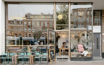 Chic storefront at Overtoom 141 in Amsterdam West, showcasing an inviting office space rental with large windows and a trendy exterior.