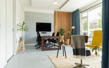 Inviting office space rental at Overtoom 141 in Amsterdam West with a modern desk, comfortable seating, and ample natural light.