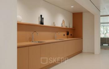 Contemporary office space at Nachtwachtlaan 20 in Amsterdam West, featuring a sleek kitchenette with modern fixtures. Ideal for those seeking office space rental.