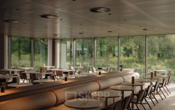 Spacious office interior with large windows at Nachtwachtlaan 20, Amsterdam West, suitable for office space rental.