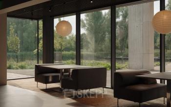 Spacious office at Nachtwachtlaan 20, Amsterdam West, featuring large windows and modern furnishings, perfect for office space rental.