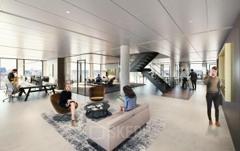 Spacious office environment at Kon. Wilhelminaplein 4, Amsterdam West, showcasing modern furniture and employees engaged in work activities. Ideal for office space rental opportunities.