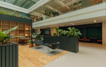 Modern office space available for rent at Kon. Wilhelminaplein 4, Amsterdam West. Spacious open floorplan adorned with greenery and natural light. Ideal for office space rental.