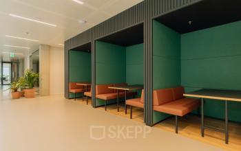 Modern alcove seating area in a stylish office at Kon. Wilhelminaplein 4, ideal for rent office space in Amsterdam West.