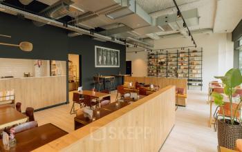 Spacious office to rent in Amsterdam West with modern furnishings, wooden accents, and an organized layout, ideal for collaborative workspaces.