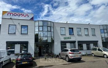 Exterior of office building located at Gyroscoopweg 23-25, Amsterdam Westpoort, showing a modern facade with ample parking space.