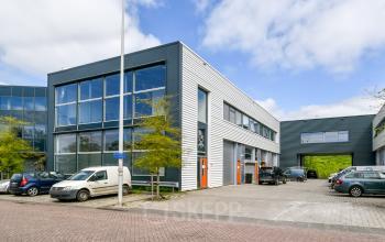 Exterior view of an office building at Poortland 242, Amsterdam Westpoort, featuring modern architecture with large windows. Ideal for businesses looking for office space rental in a vibrant location.