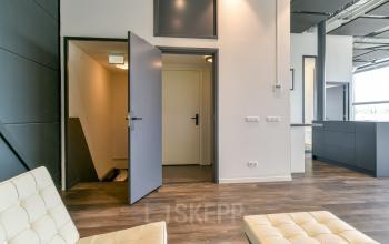 Modern office interior at Poortland 242, Amsterdam Westpoort featuring sleek chairs, open floorplan with natural light, ideal for office space rental.