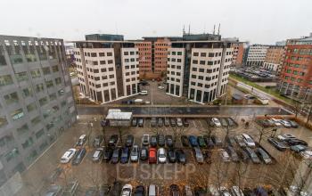 View of an urban office district with modern buildings and a spacious parking lot in Amsterdam South East.