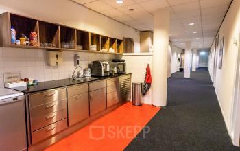 Office pantry at Hullenbergweg 278 in Amsterdam South East, available for office space rental. Features modern appliances and sleek cabinets, perfect for an efficient workspace.