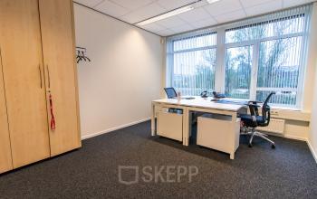Bright office space to rent at Hullenbergweg 278 in Amsterdam South East, featuring large windows, desks, and chairs, ideal for a productive work environment.