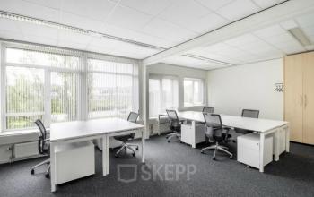 Bright office space for rent at Hullenbergweg 278, Amsterdam South East, featuring large windows and modern furnishings with desks and chairs.