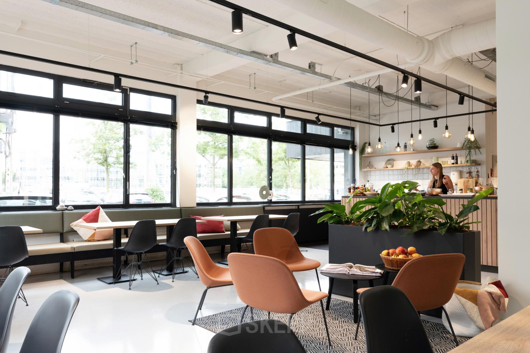 Modern office space rental at Hogehilweg 19, Amsterdam South East, with stylish furnishings and large windows offering ample natural light.