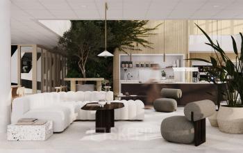 Stylish office to rent in Amsterdam South East with modern seating, lush plants, and a well-equipped coffee area, perfect for hosting informal meetings.
