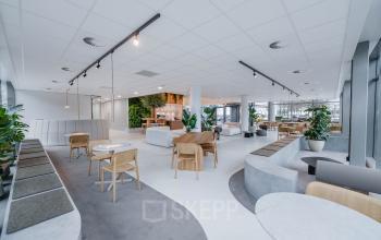 Spacious and modern office to rent in Amsterdam South East, featuring stylish furnishings and ample seating areas.