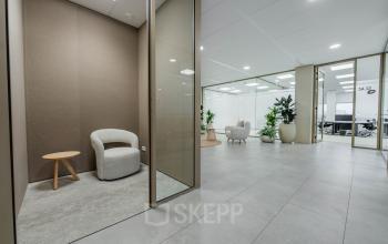 Modern office space at Laarderhoogtweg 7-19, Amsterdam South East featuring a seating area and plants, perfect for office space rental.