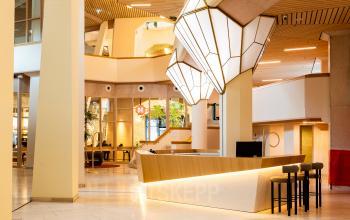 Modern office to rent featuring a stylish reception area with sleek lighting and contemporary design at Bijlmerplein 888, Amsterdam South East.