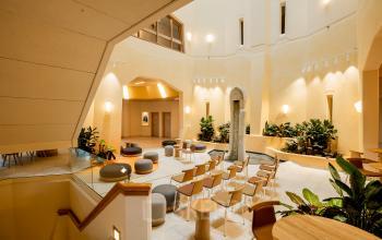 Spacious office interior at Bijlmerplein 888, Amsterdam South East, featuring modern seating arrangements and vibrant natural light, perfect for office space rental.