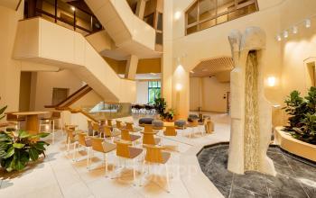 Bright office interior at Bijlmerplein 888, Amsterdam South East, featuring modern seating and a unique stone sculpture, ideal for office space rental or an office to rent.