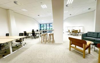 Spacious, well-lit office for rent at Bijlmerplein 888 in Amsterdam South East, featuring modern furnishings and an open work area with desks, chairs, and seating options.