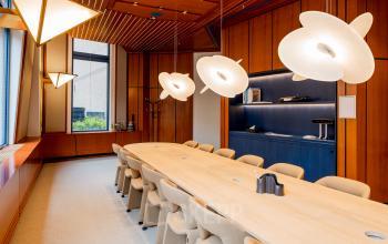 Modern office to rent at Bijlmerplein 888, Amsterdam South East, featuring a stylish conference room with elegant lighting and contemporary furnishings.