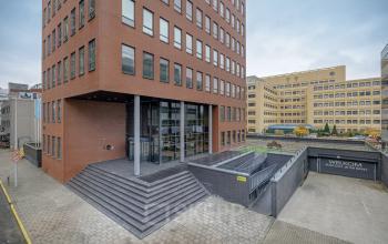 Exterior view of office building at Hogehilweg 24, Amsterdam South East, showcasing modern architecture with brick facade and welcoming entrance steps. Ideal for office space rental in a bustling business area.