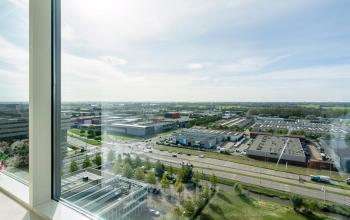 Panoramic view from the office at De Entree 230-266, Amsterdam South East, showcasing the surrounding business district and highway. Ideal for those seeking office space rental with scenic vistas.