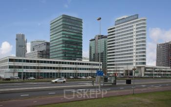 Modern office building exterior at De Entree 230-266 in Amsterdam South East with sleek architecture, featuring a mix of glass and concrete surfaces. Ideal for those seeking office space rental in a vibrant business district.