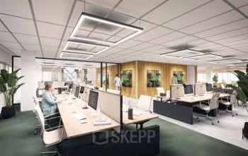Spacious, well-lit office to rent at Herikerbergweg 288, Amsterdam South East, featuring modern workstations, greenery, and employees engaged in collaborative business activities.