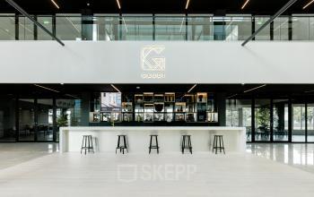 Spacious and modern interior with seating options at a bar-style counter, perfect for office space rental at Herikerbergweg 288, Amsterdam South East.