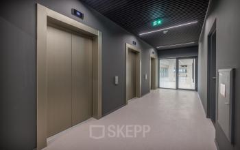 Modern hallway with elevators at the Herikerbergweg 288 office building in Amsterdam South East, ideal for those seeking office space rental.